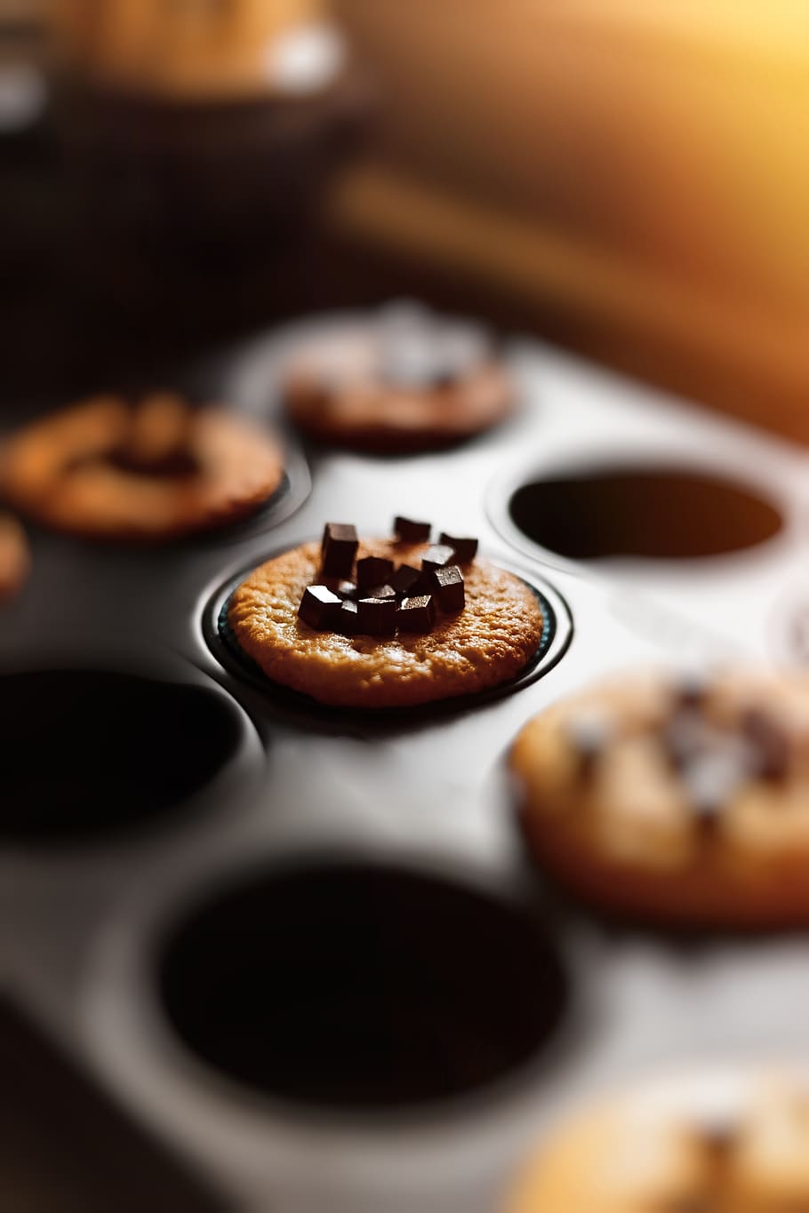 Selective Focus Photography Of Baked Cupcake In Tin With Chocolate Bits On Top HD wallpaper