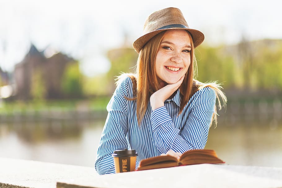 Focus Photography Smiling Woman While Reading Book, adult, attractive