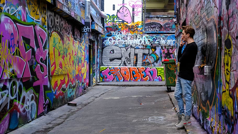 man leaning beside multi-colored wall, graffiti, creativity, one person HD wallpaper