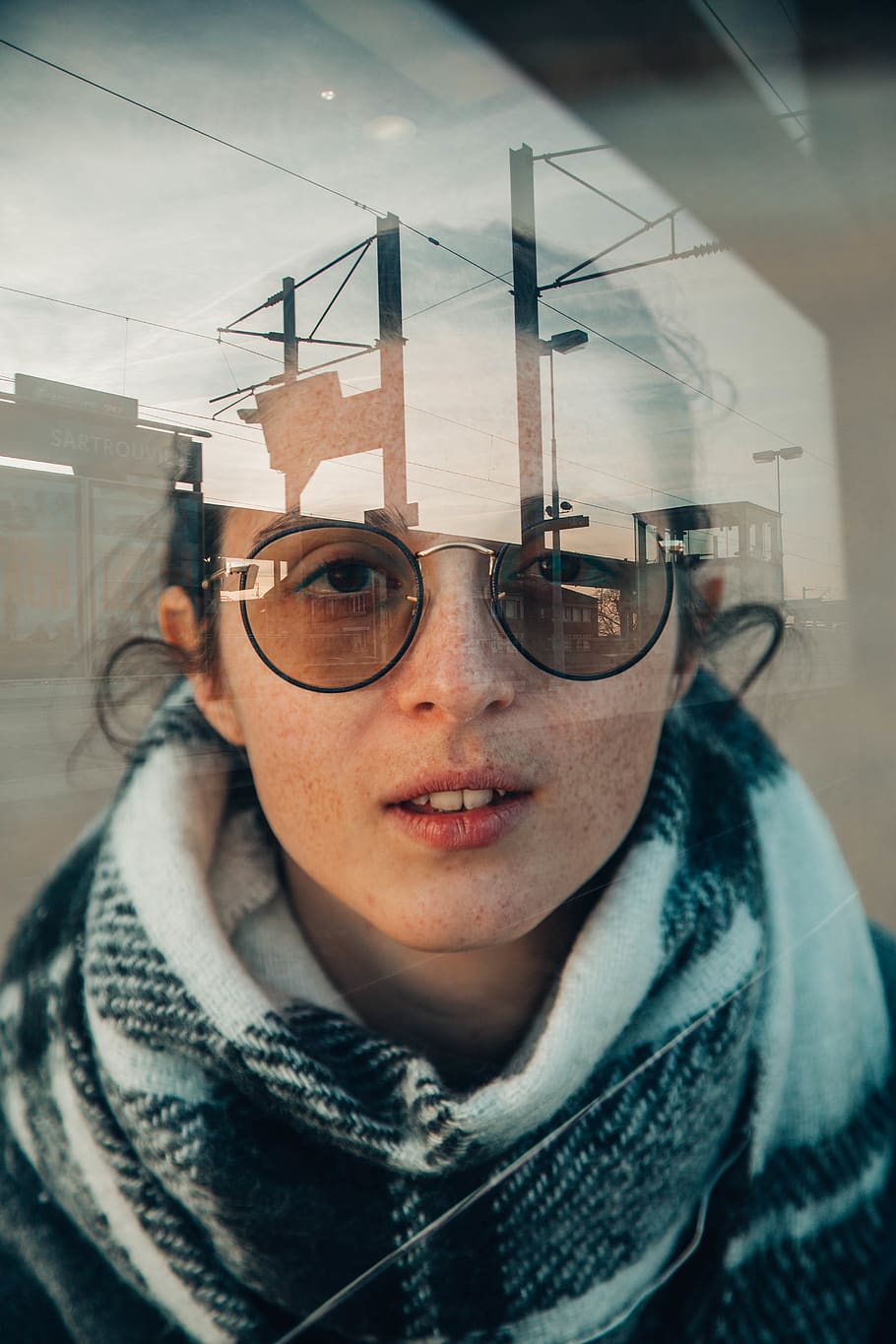 woman wearing sunglasses inside glass panele, headshot, eyeglasses