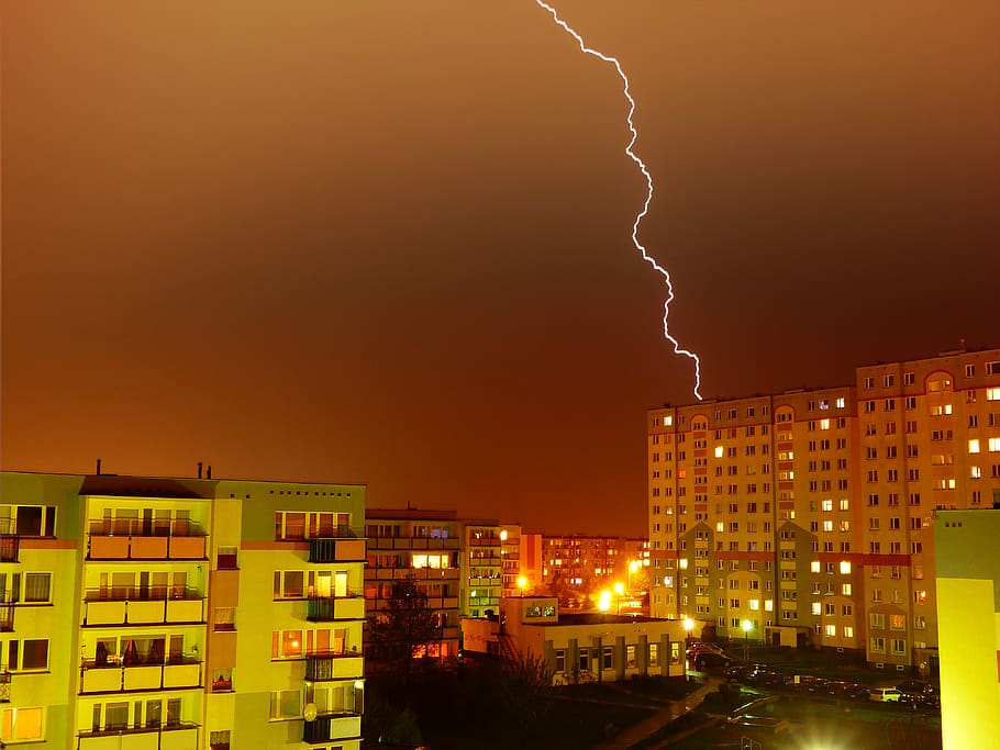 aerial photography of buildings and road under cloudy skies with lightning, HD wallpaper