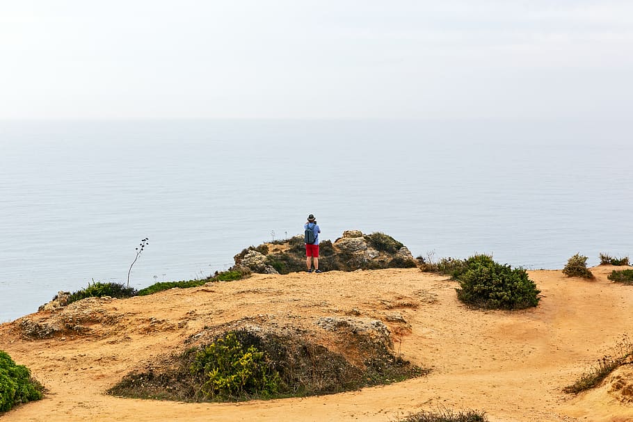 Person Standing Near Rocks, cliff, Cliff Edge, day, daylight HD wallpaper