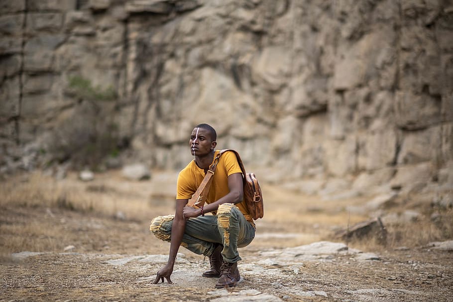 Man Crouching On Ground, face paint, person, style, wear, one person