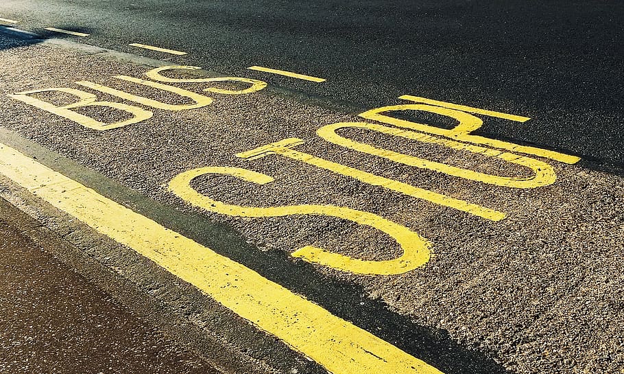 Bus Stop Printed on Asphalt Road, close-up, daylight, guidance HD wallpaper