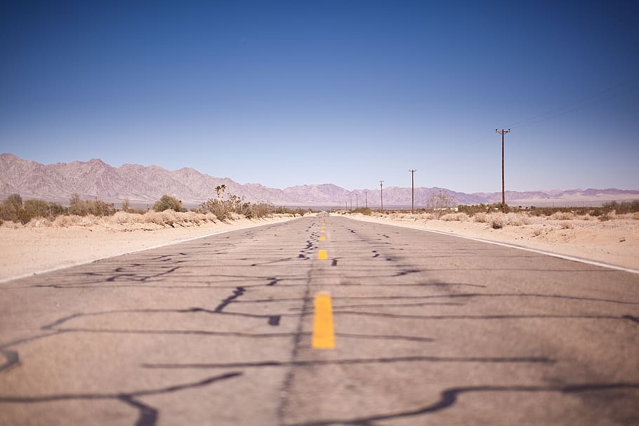Asphalt Road Under the Clear Blue Skies during Daytime, barren HD wallpaper