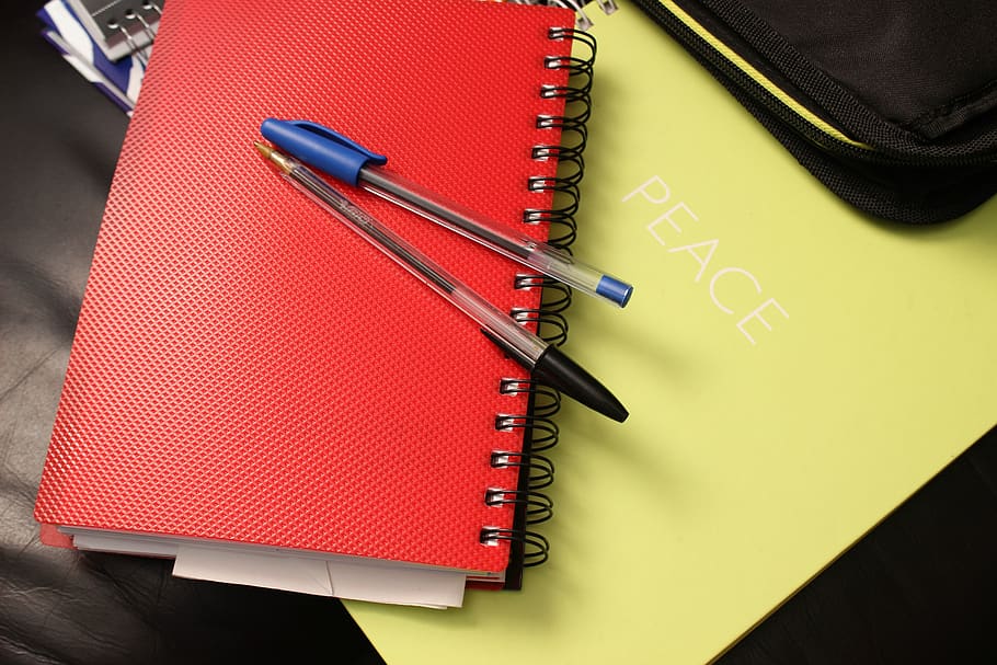 Blue and Black Ball Point Pens on Red Hand Book, binders, spiral notebook HD wallpaper