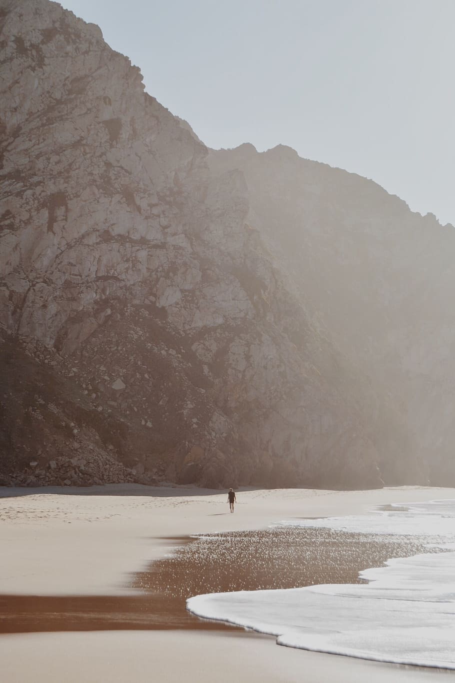 person walking seaside during daytime, mountain, rock, cliff HD wallpaper