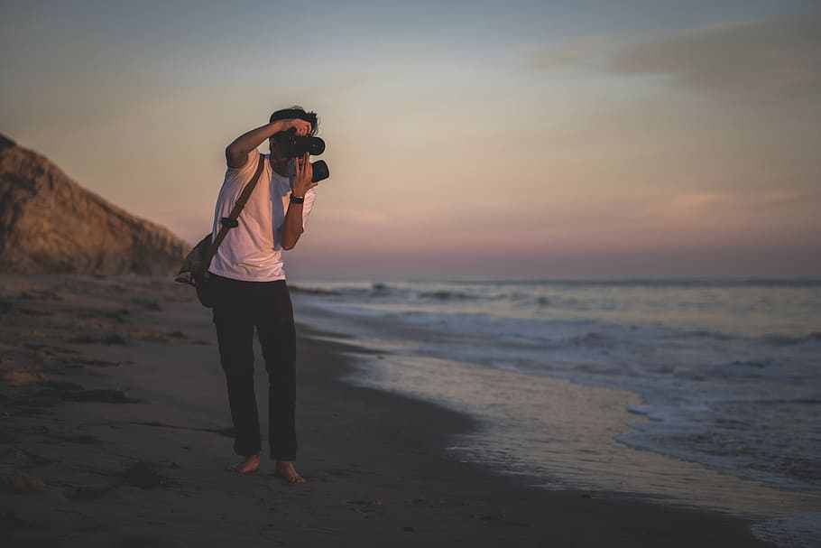 Man Taking Photo Outdoors, beach, camera, clouds, evening, golden hour HD wallpaper