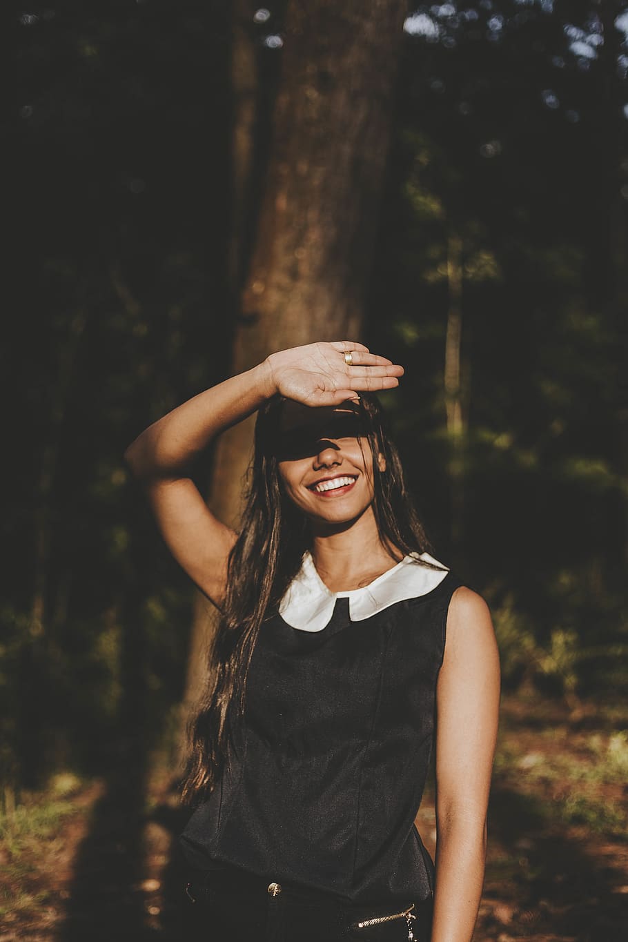 Smiling Woman Wearing White and Black Sleeveless Shirt Near the Tree Outdoor HD wallpaper