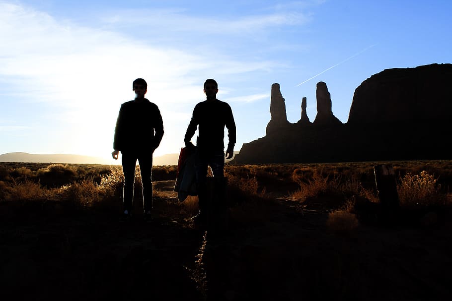 Silhouette of Two Person Standing on the Desert, backlit, clouds HD wallpaper