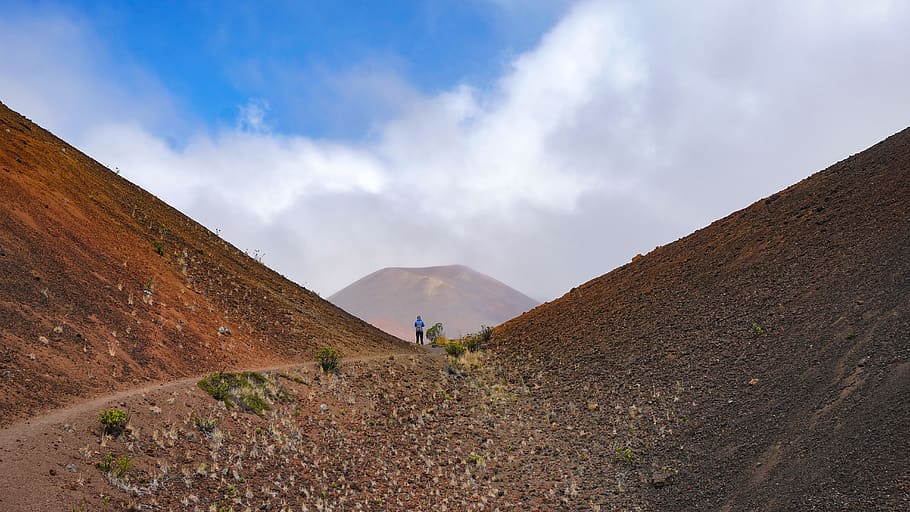 person between brown mountains, gravel, dirt road, nature, slope HD wallpaper