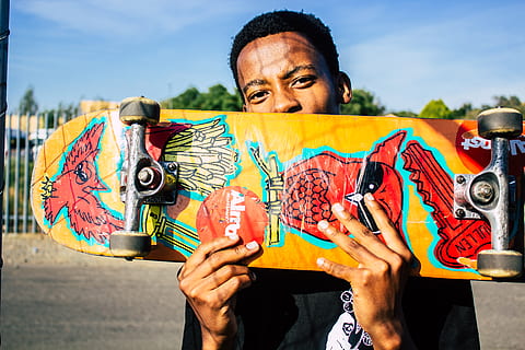 man holding skateboard, human, person, finger, animal, mammal HD wallpaper