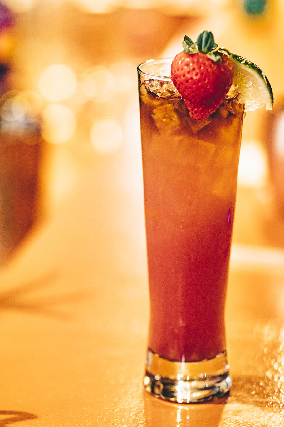 strawberry drink on glass on top of brown table, food and drink