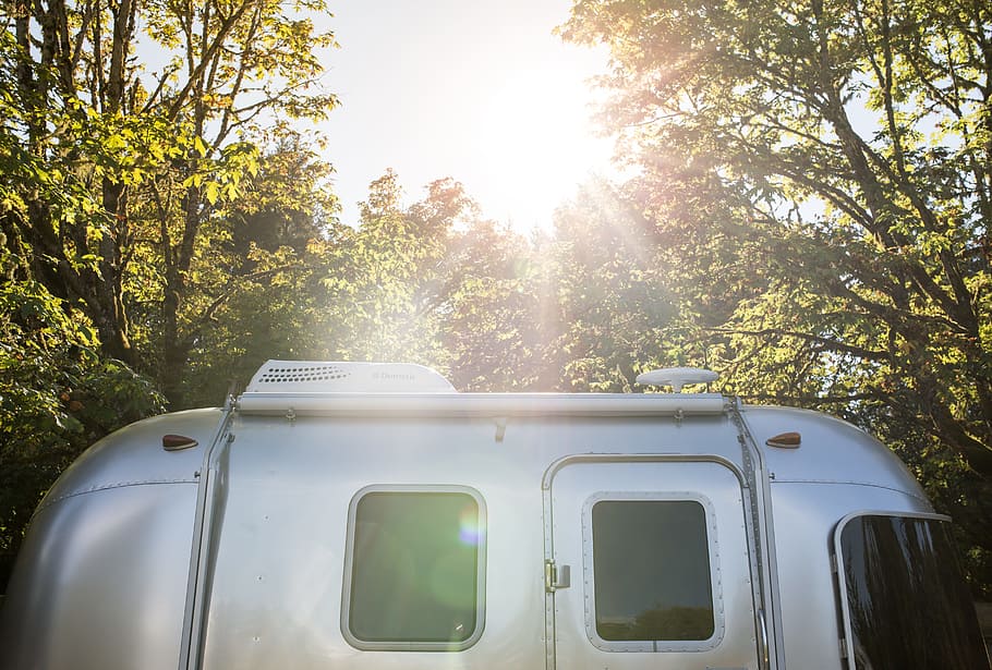 silver RV trailer near trees, caravan, sunset, sunrise, camping HD wallpaper