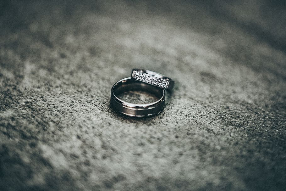 silver-colored rings on gray pavement, jewelry, wedding ring HD wallpaper