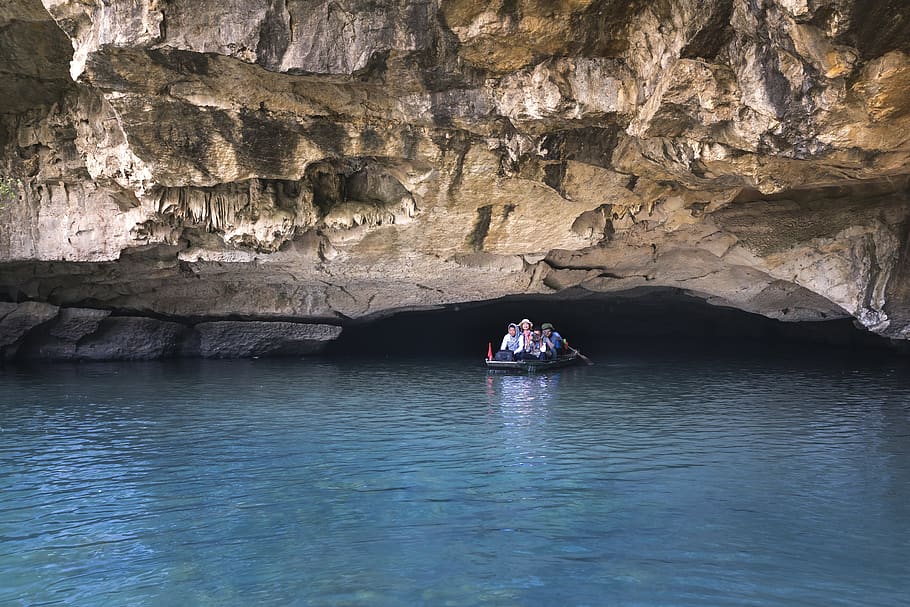 People on Boat Under Cave, adventure, daylight, exploration, island HD wallpaper