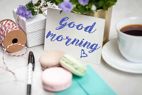 Filled Teacup With Saucer Beside Good Morning Card and Pen and Macaroons HD wallpaper