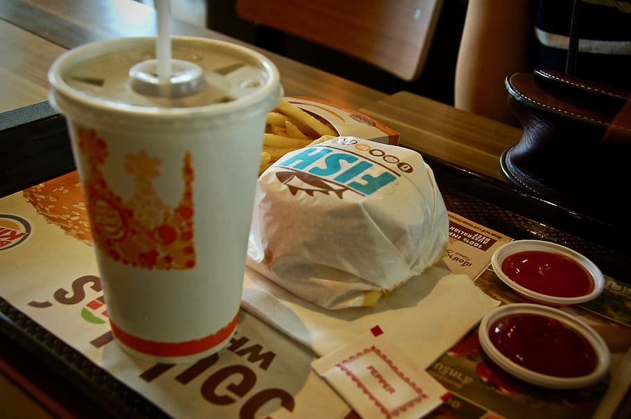 photo of Burger King burger beside cup and ketchup serving on tray