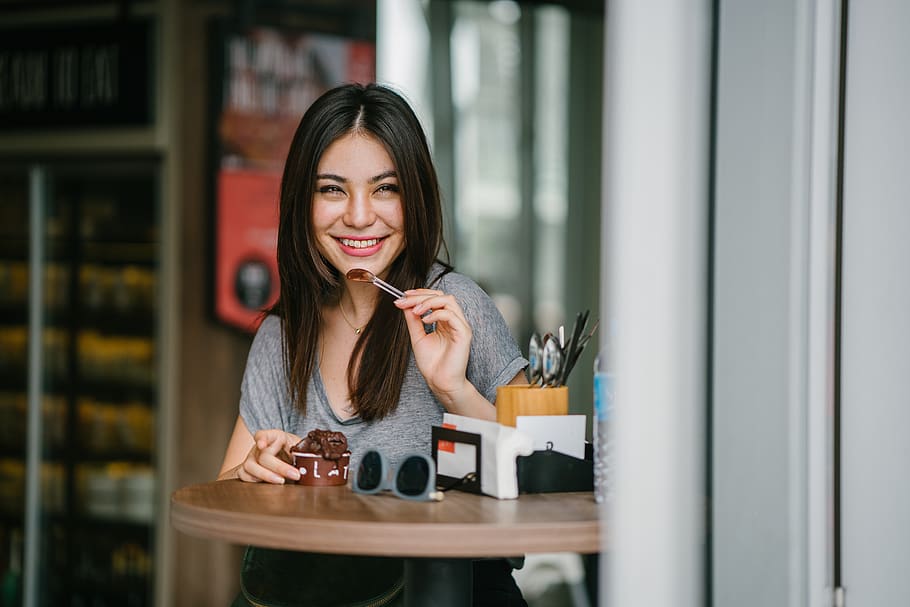 Woman Sitting at Table Holding Ice Cream, beautiful, blurred background HD wallpaper