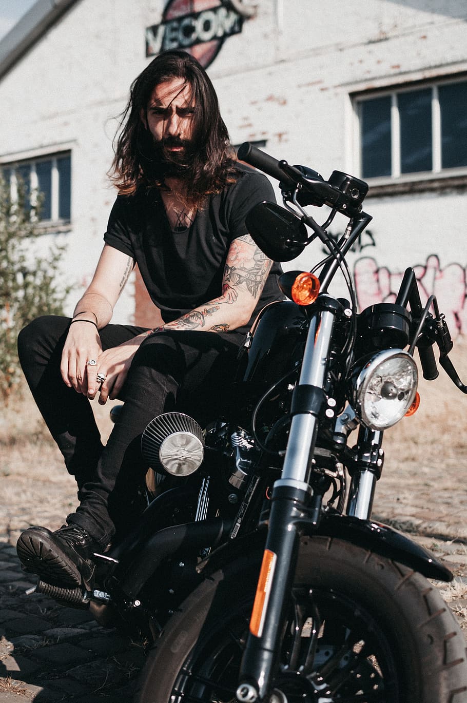 man sitting on black cruiser motorcycle, biker, tattoo, harley