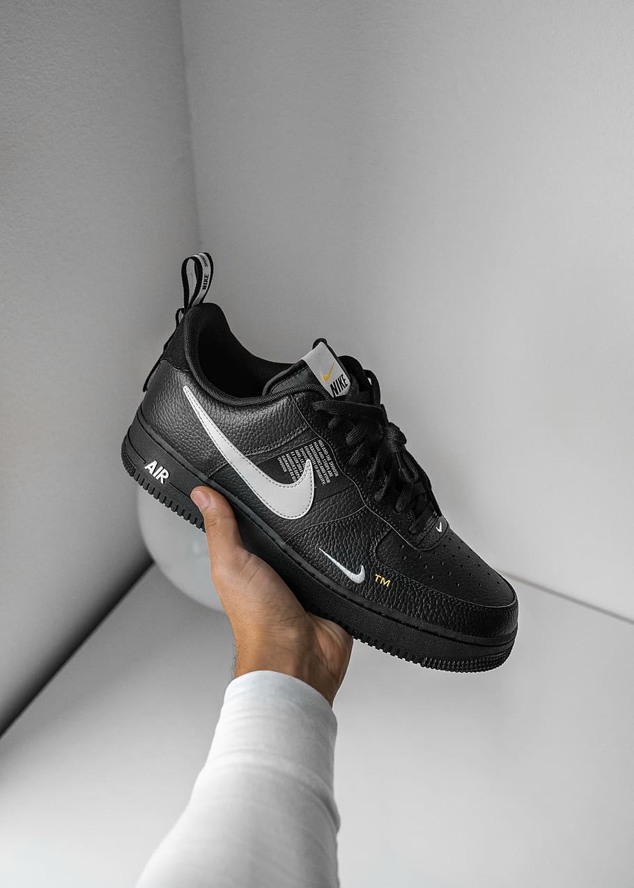 black and white Nike Air Force 1 sneaker, human body part, one person