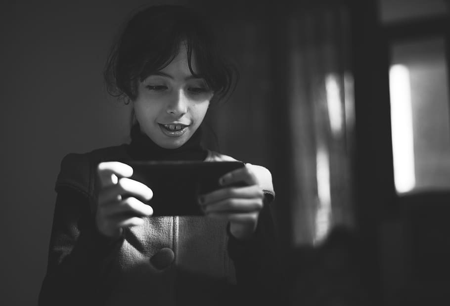 Grayscale Photography of Girl Using Smartphone, adorable, black-and-white