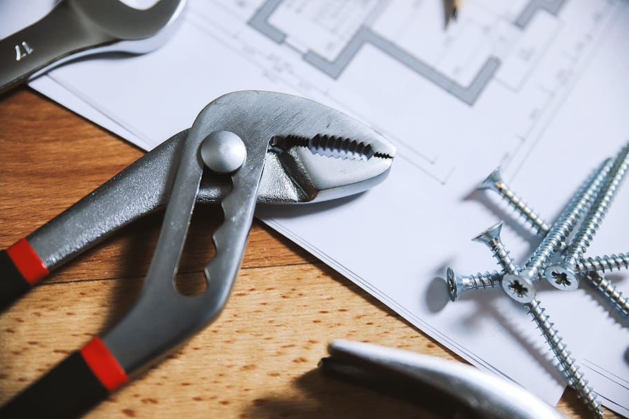 Pliers and nails on a wooden floor with house plans, work tool HD wallpaper