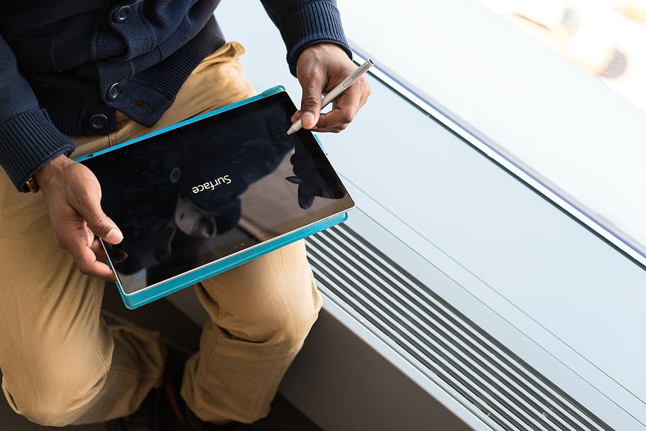 Person Wearing Brown Pants Holding Black Tablet Computer, device HD wallpaper