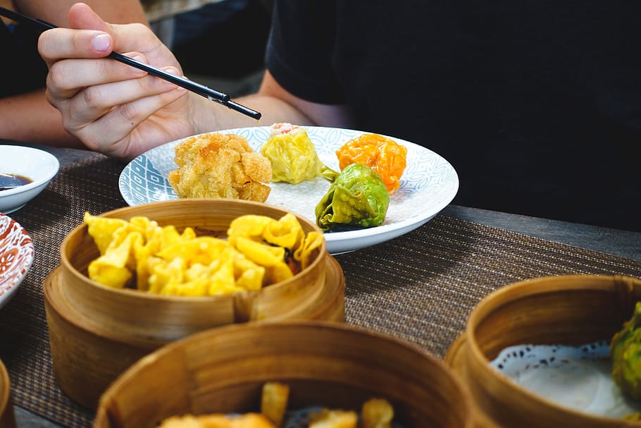 Eating Chinese steamed and fried dim sum with chopsticks, asian
