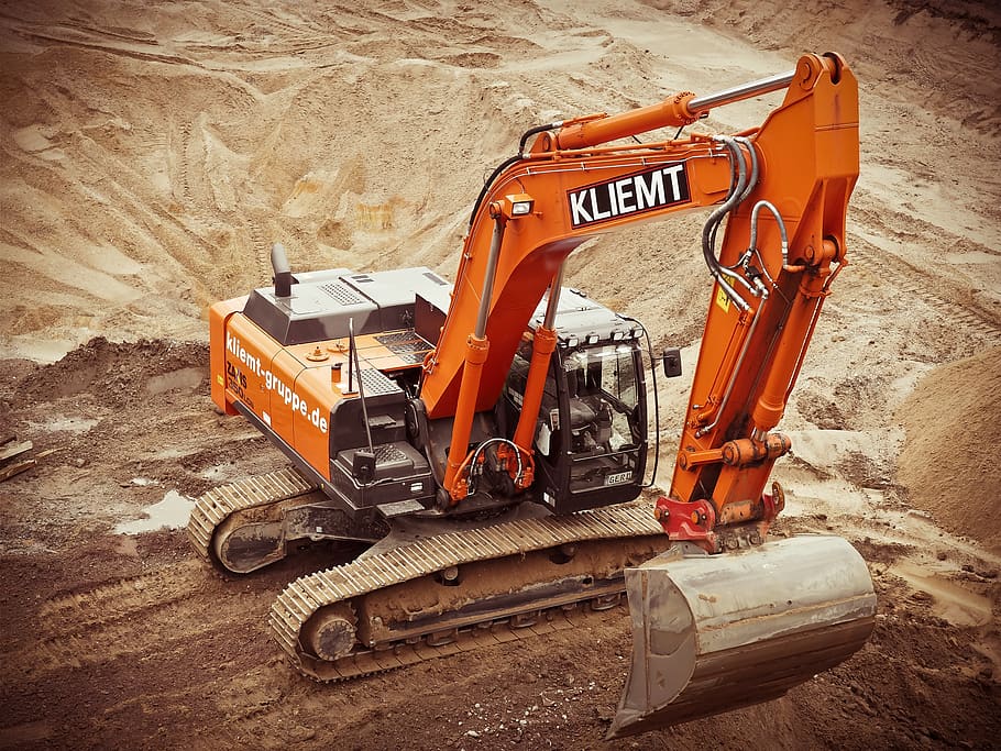 Orange Kliemt Excavator on Brown Soil, blade, bucket, construction