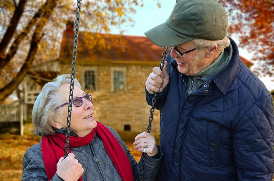 Man Standing Beside Woman on Swing, care, chain, couple, elderly HD wallpaper