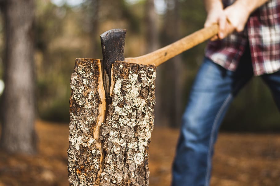 man holding brown axe towards firewood on selective focus photography, HD wallpaper