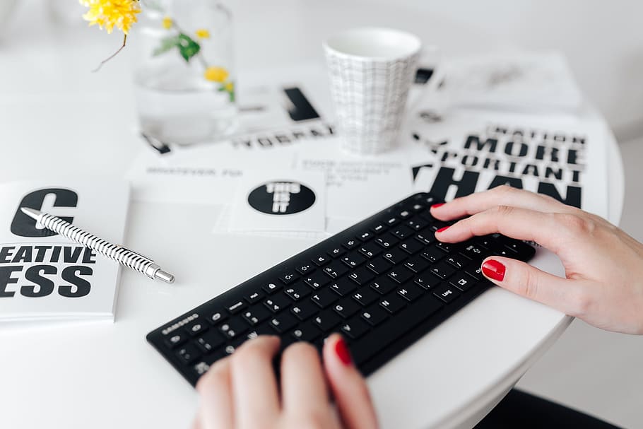 Female hands typing on the remote wireless computer keyboard HD wallpaper
