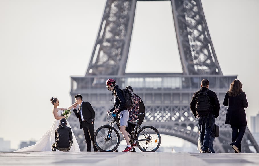 man riding on bike while looking to the couple, transportation HD wallpaper