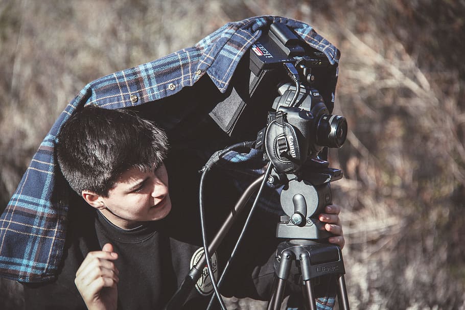 Photo of Man Setting Up Dslr Camera on Tripod, daytime, equipment HD wallpaper