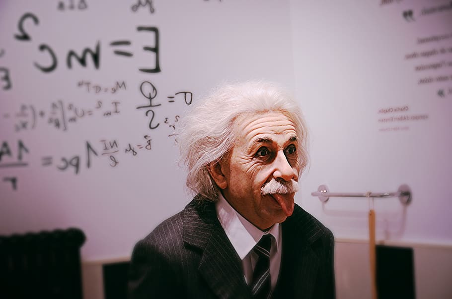 Albert Einstein licking tongue, person, human, suit, clothing