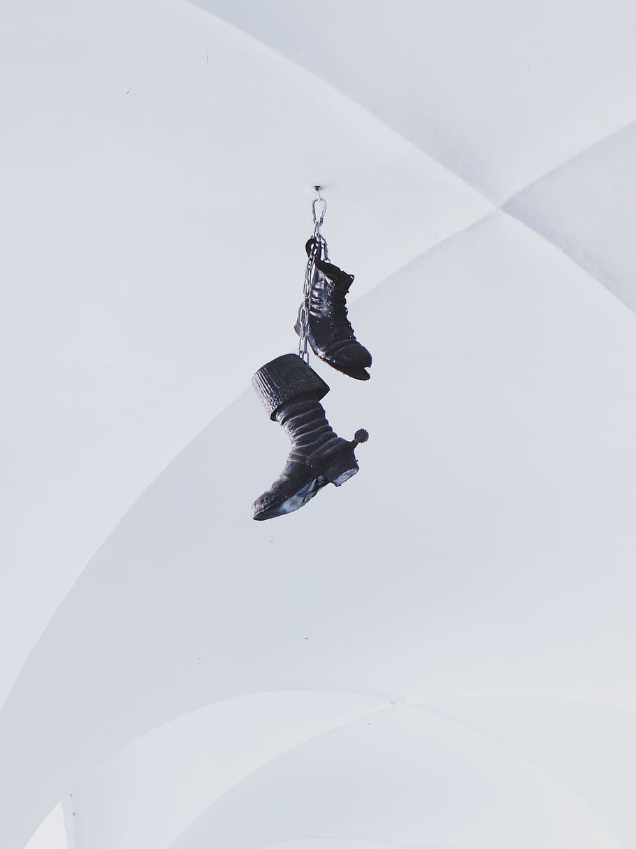 Pair of Black Boots Hanging on White Wall, footwear, full length