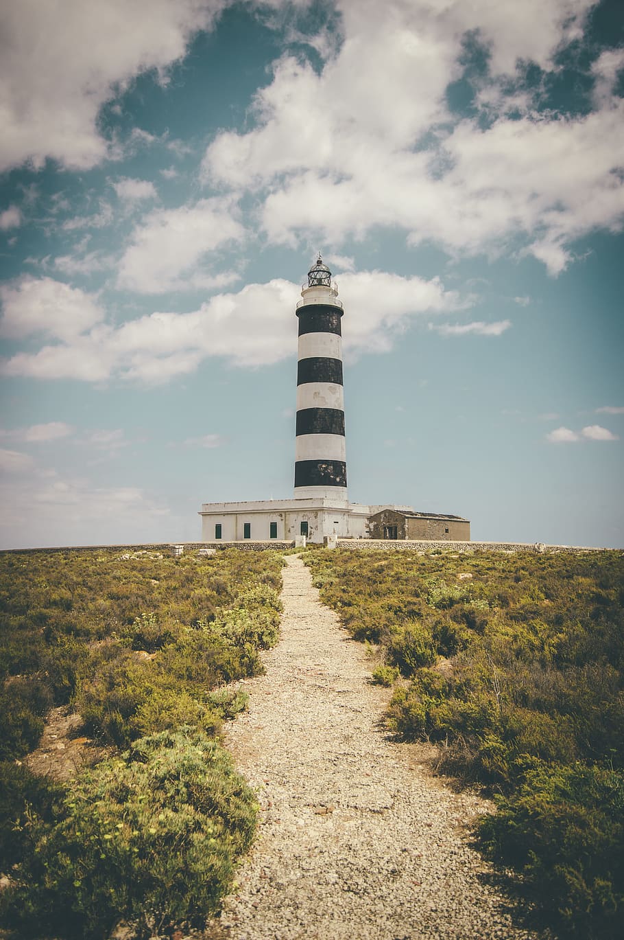 lighthouse under cumulus clouds and blue calm sky, path to lighthouse HD wallpaper