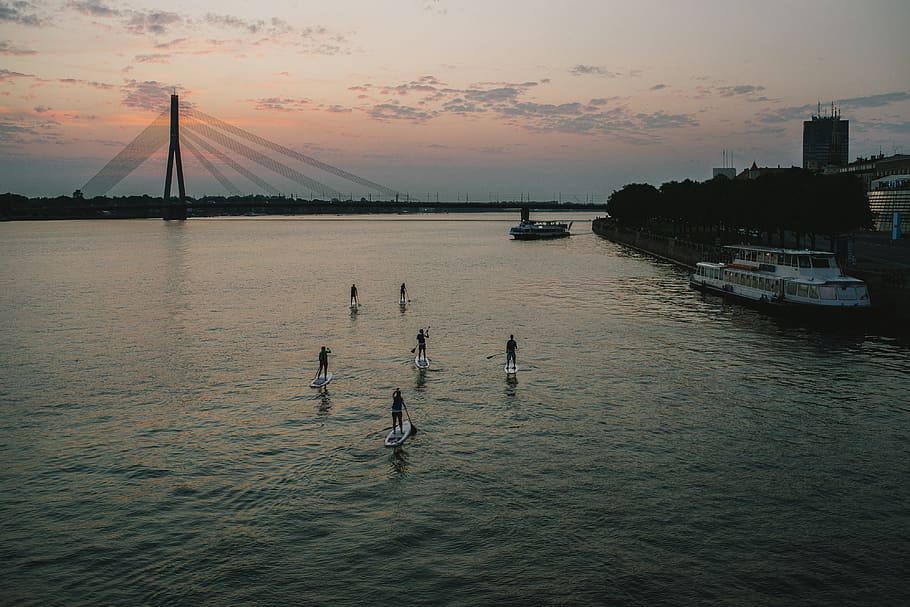 Paddleboarding at sunset, activity, boats, bridge, daugava, exercise HD wallpaper
