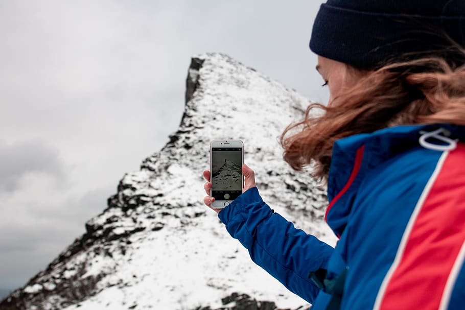 woman taking picture on mountain, cell phone, electronics, mobile phone