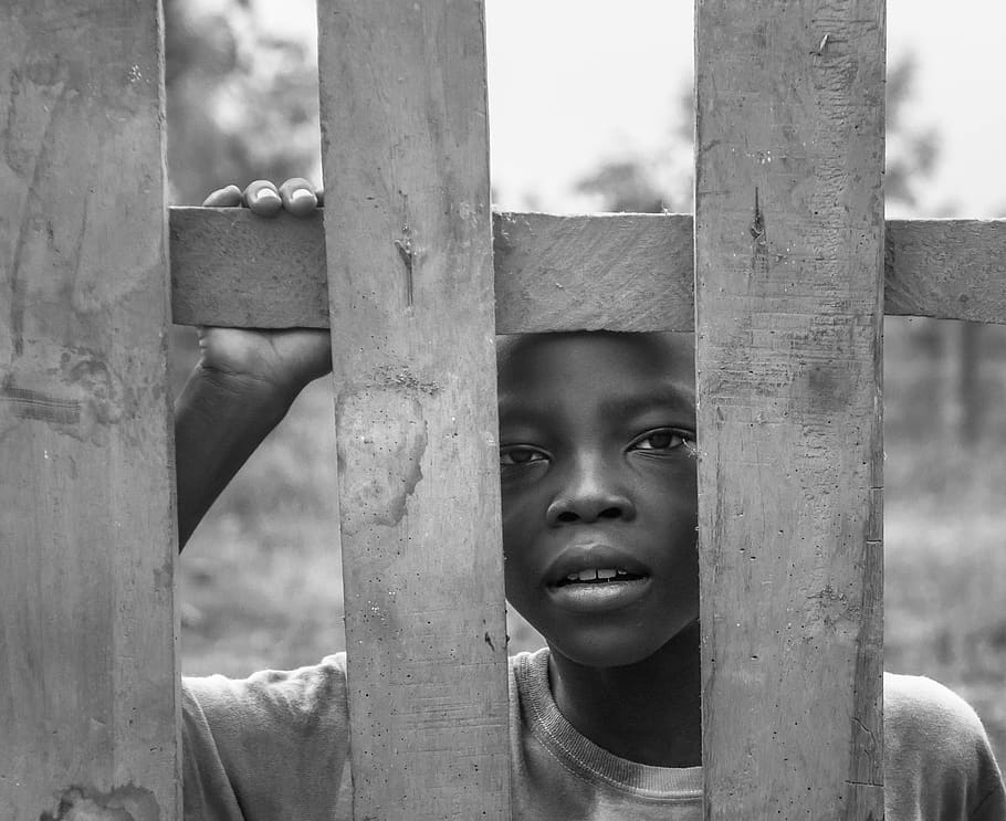 HD wallpaper: Grayscale Photo of Boy Standing Behind Wooden Fence