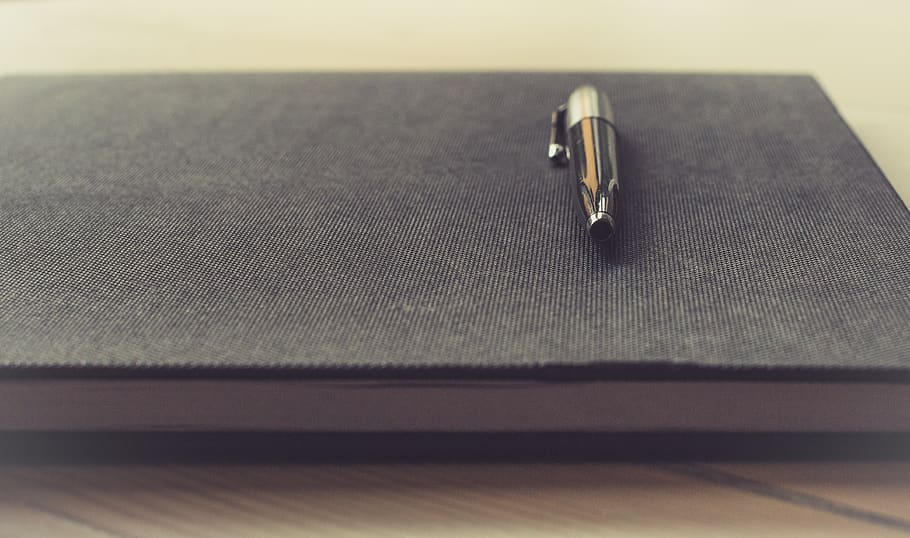 gray click pen on black book, indoors, close-up, metal, still life HD wallpaper
