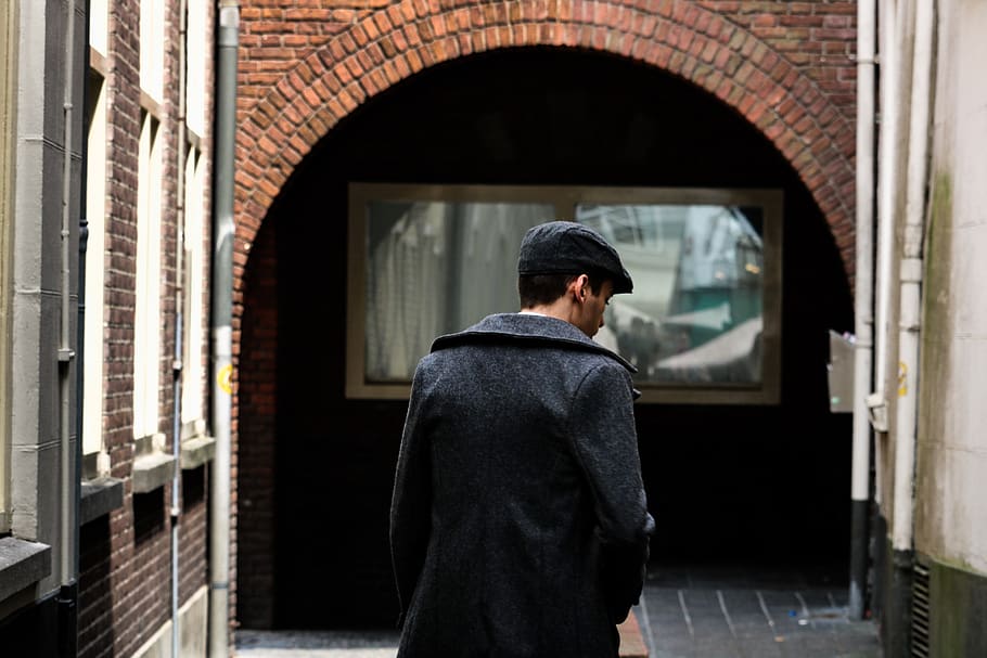 Man on Narrow Pathway Between Concrete Buildings, arch, back HD wallpaper