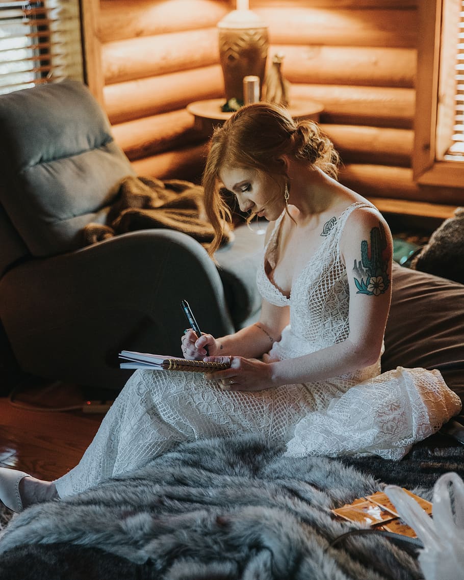 bride writing on notebook while sitting on bed, indoors, art and craft HD wallpaper