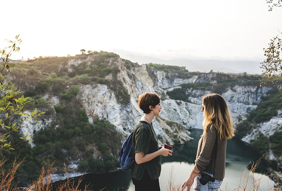 Two Women Standing Overlooking Lake, adventure, backpack, backpacker HD wallpaper