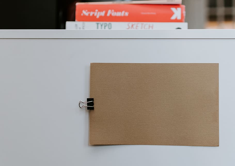 brown paper on white board, no people, text, close-up, indoors HD wallpaper