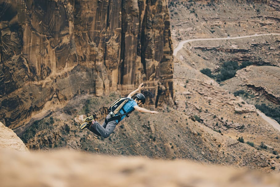 man jumping on cliff, nature, person, human, outdoors, mountain HD wallpaper