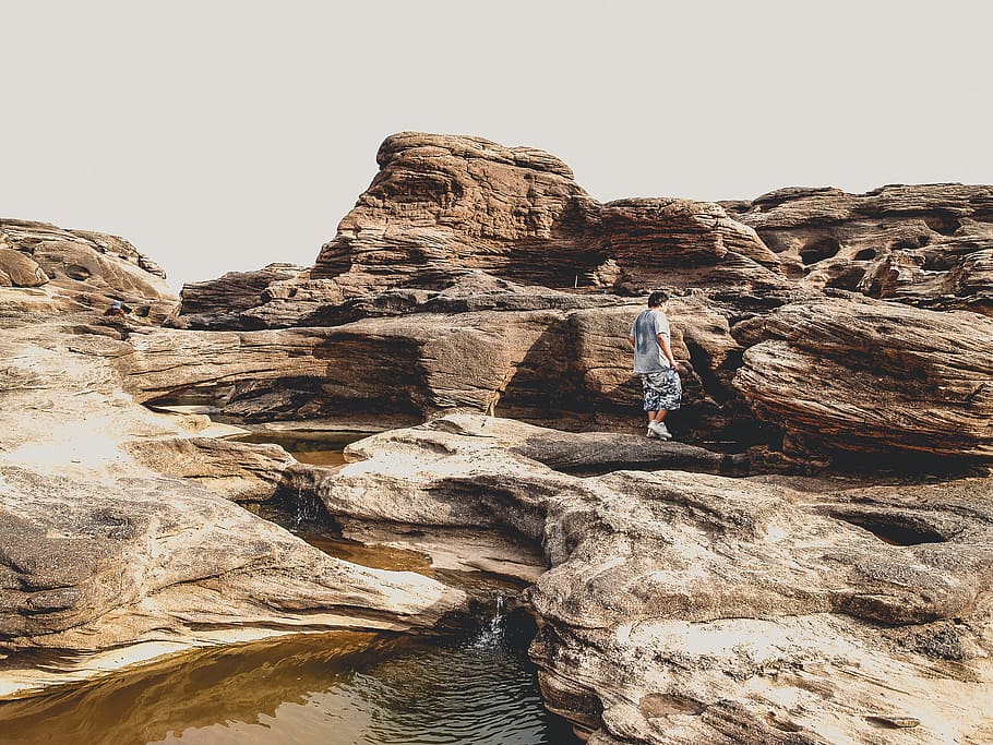 Person Standing on Brown Rocks, background, beautiful, calm, daylight HD wallpaper