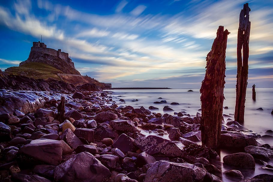 Rocks Near Body of Water, ancient, beach, clouds, coast, coastline HD wallpaper