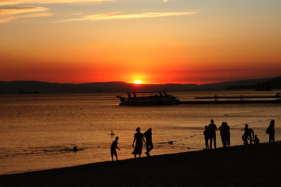 people, sunset, silhouette, twilight, sky, sea, evening, water HD wallpaper